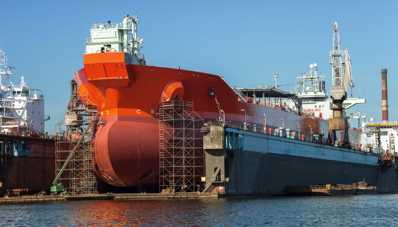 A large tanker repairs in dry dock. Shipyard Gdansk, Poland.